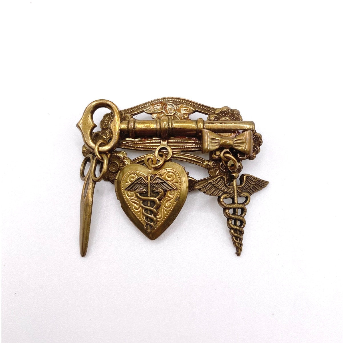 Vntg Pin Filigree Charms Of Health Caduceus Symbol Scissors and Heart Locket