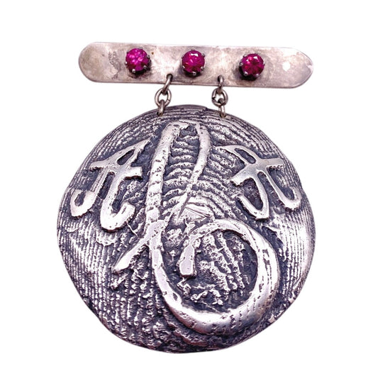 Vintage Metal Anagram Design With Three Median Rubies 2” Round