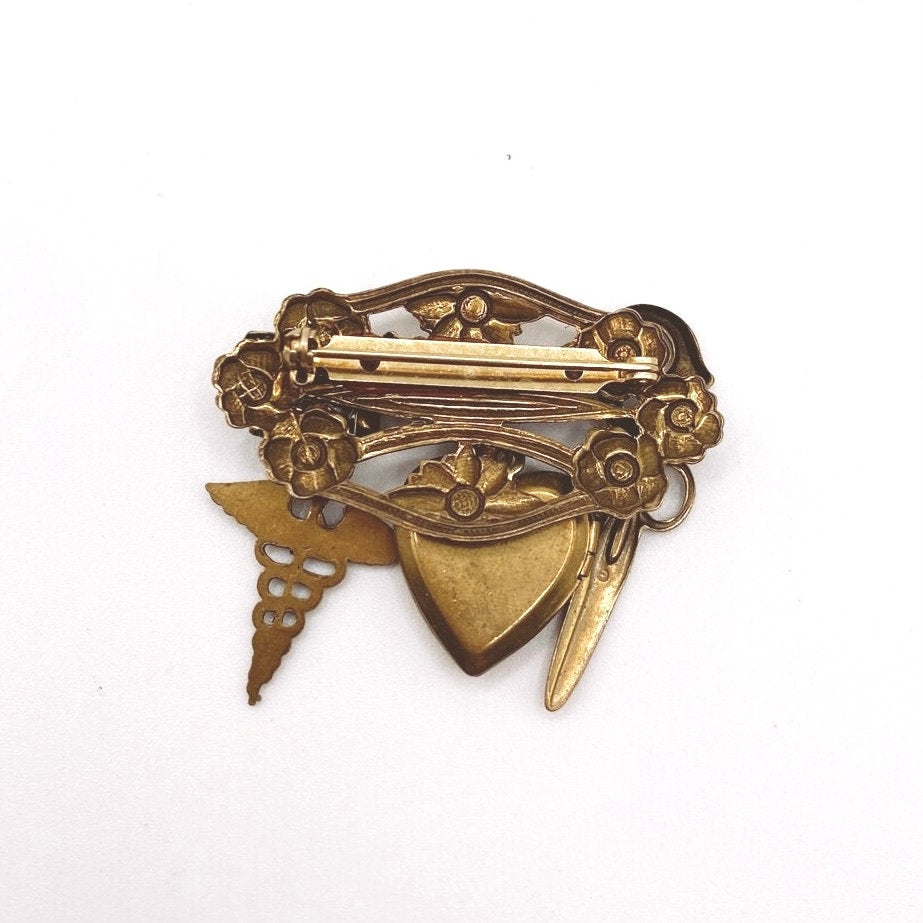 Vntg Pin Filigree Charms Of Health Caduceus Symbol Scissors and Heart Locket