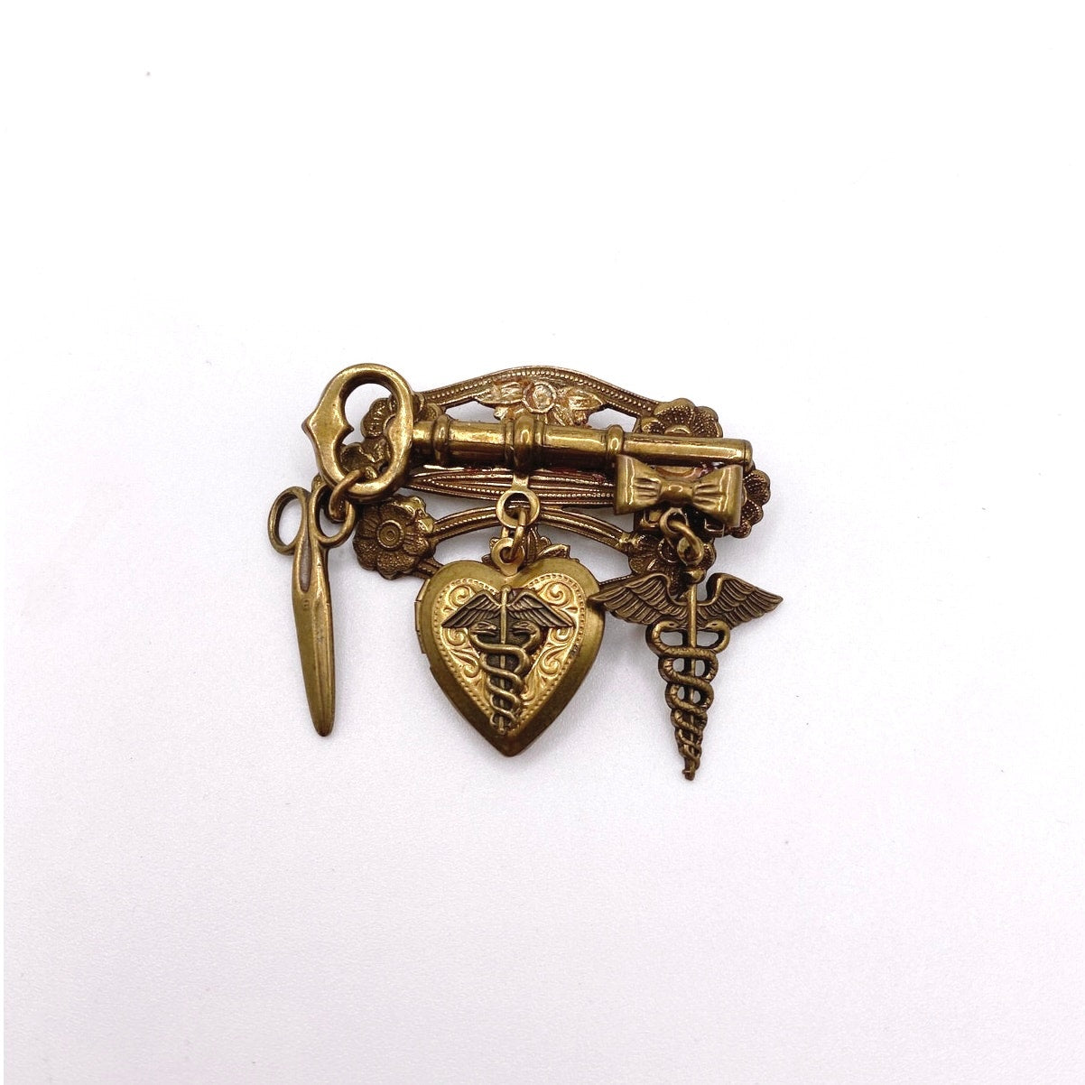 Vntg Pin Filigree Charms Of Health Caduceus Symbol Scissors and Heart Locket