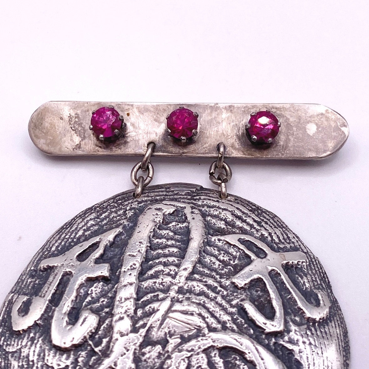 Vintage Metal Metal Anagram Design With Three Median Rubies 2” Round