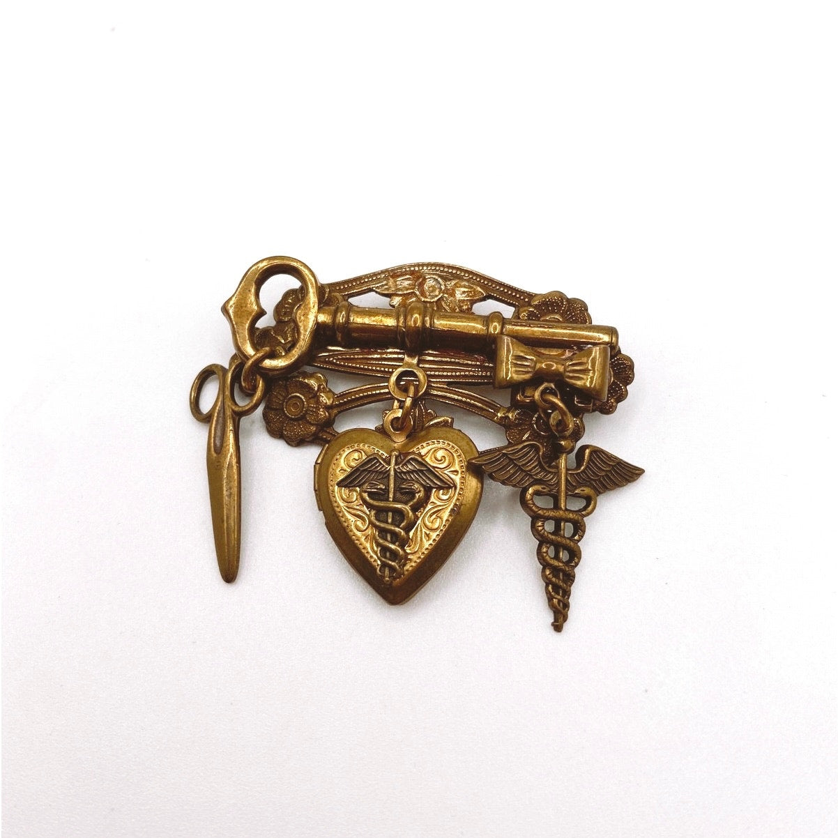 Vntg Pin Filigree Charms Of Health Caduceus Symbol Scissors and Heart Locket