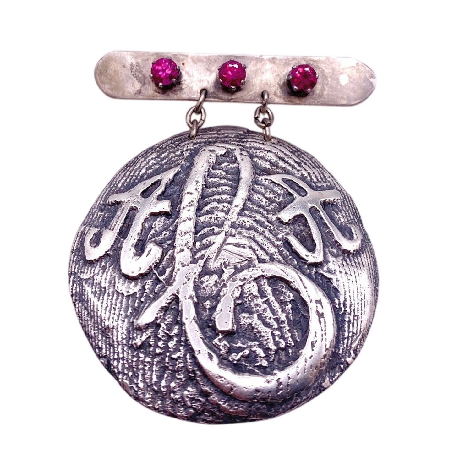 Vintage Metal Metal Anagram Design With Three Median Rubies 2” Round