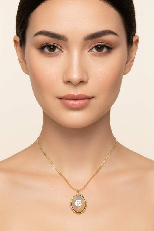 An oval pendant necklace featuring a polished tiger's eye stone with a gold Chinese character '福' (fortune) in the center, suspended from a gold chain against a white background.